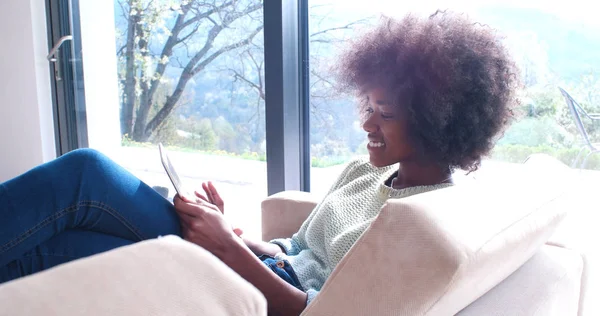 Afrikalı-Amerikalı kadın evde dijital tablet kullanma