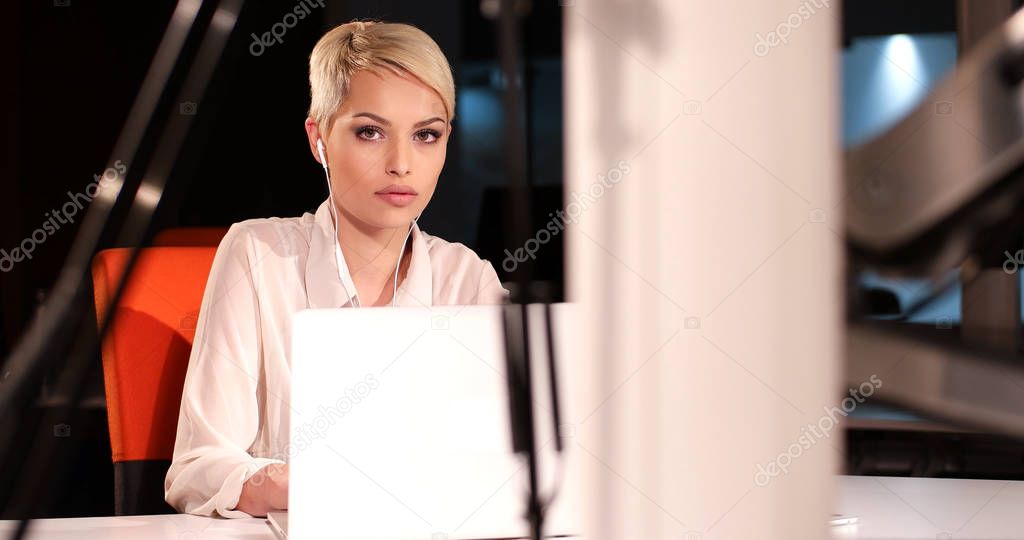 woman working on laptop in night office