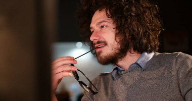 karanlık ofisinde bilgisayarda çalışan adam