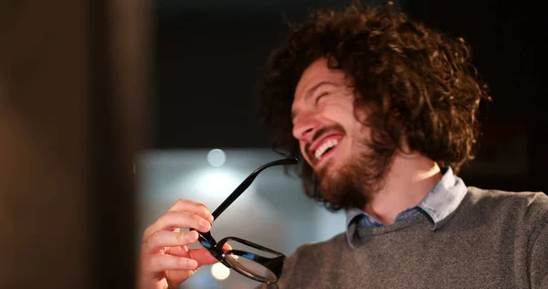 Mann arbeitet im dunklen Büro am Computer — Stockfoto