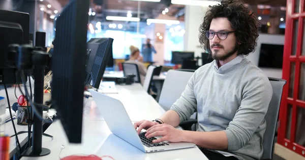 Hombre de negocios que trabaja con un ordenador portátil en la oficina de inicio —  Fotos de Stock