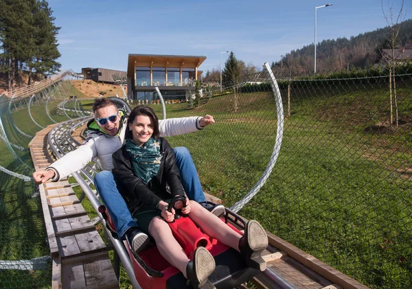 Couple enjoys driving on alpine coaster — Stock Photo, Image