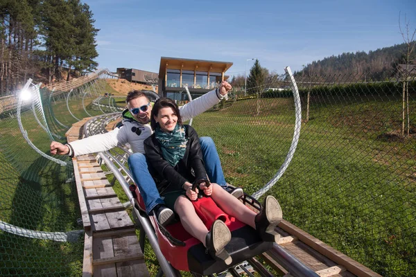 Couple enjoys driving on alpine coaster — Stock Photo, Image