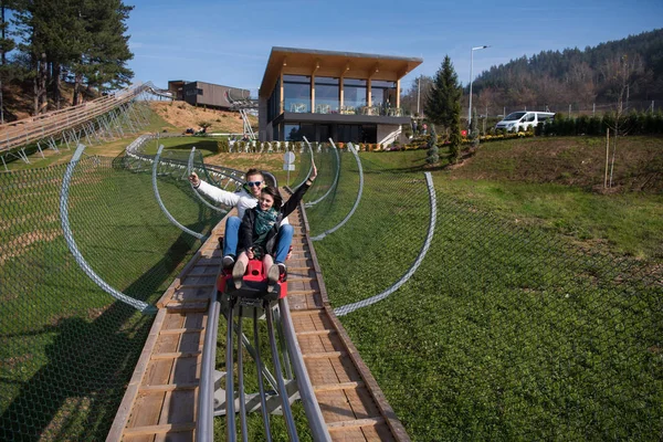 Couple enjoys driving on alpine coaster — Stock Photo, Image