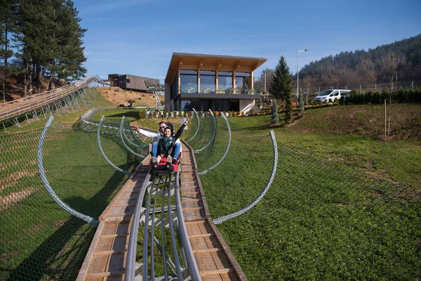 Couple enjoys driving on alpine coaster — Stock Photo, Image