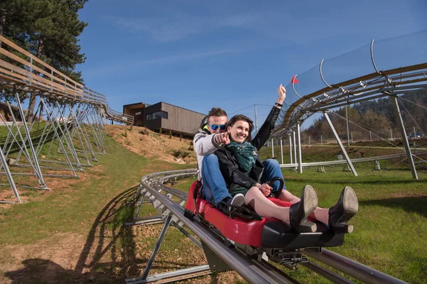 Couple enjoys driving on alpine coaster — Stock Photo, Image