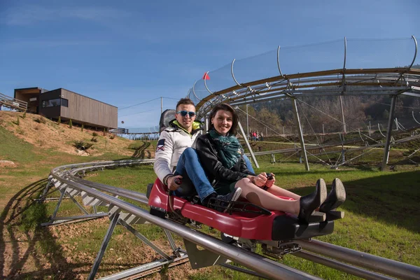 Couple enjoys driving on alpine coaster — Stock Photo, Image