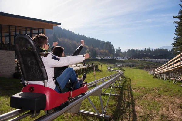 Couple enjoys driving on alpine coaster — Stock Photo, Image