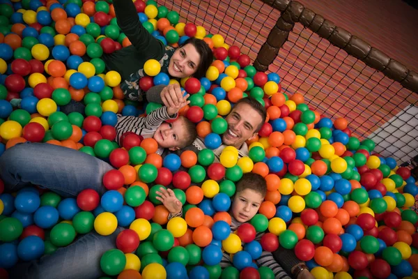Jonge ouders met kinderen in een kinder-speelkamer — Stockfoto