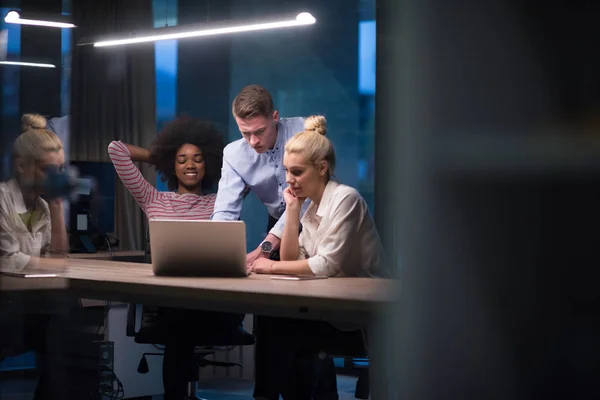 Multiethnic startup business team in night office — Stock Photo, Image