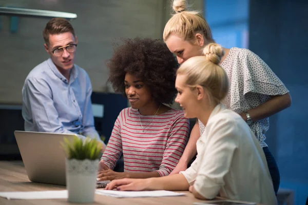 Multiethnic startup business team in night office — Stock Photo, Image