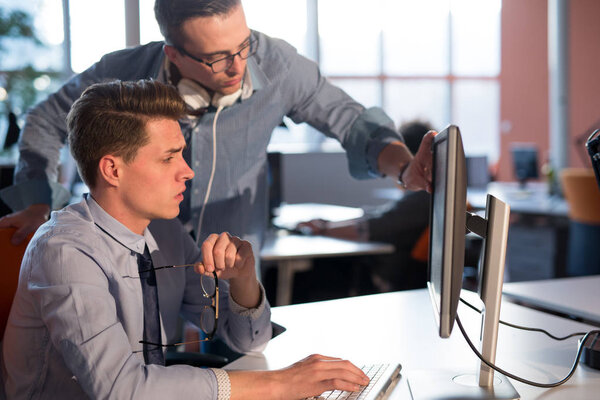 Two Business People Working With computer in office