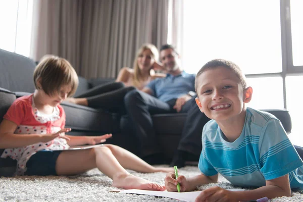 Young couple spending time with kids — Stock Photo, Image