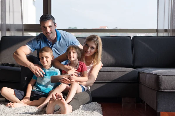 Happy young couple spending time with kids — Stock Photo, Image