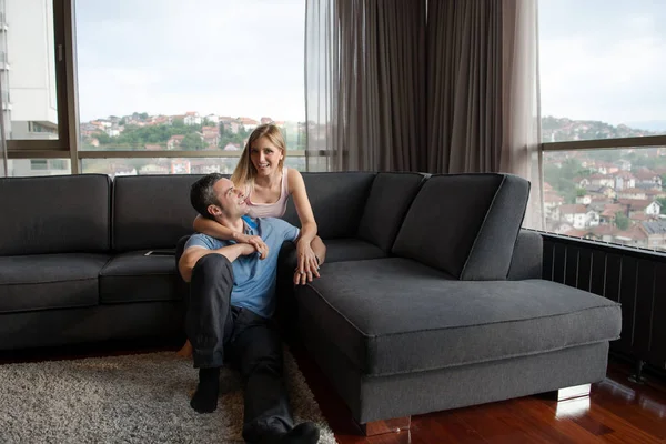 Молодая красивая пара обнимается на диване — стоковое фото