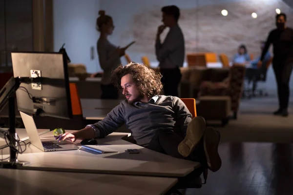 Homme d'affaires assis avec les jambes sur le bureau au bureau — Photo