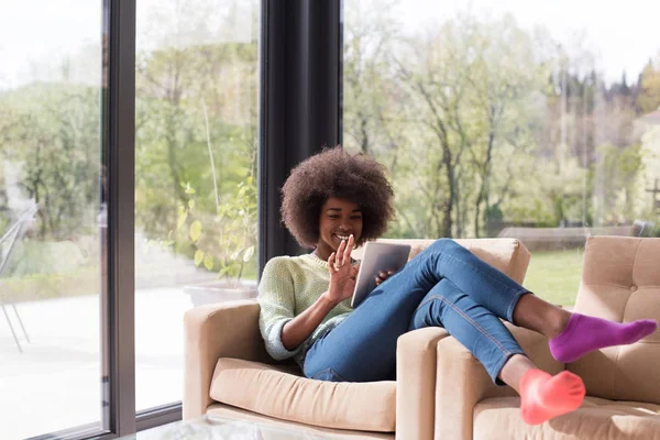 Jovem afro-americana em casa usando tablet digital — Fotografia de Stock