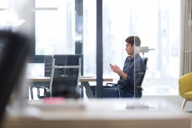 Genç sıradan iş adamı akıllı telefon kullanıyor.