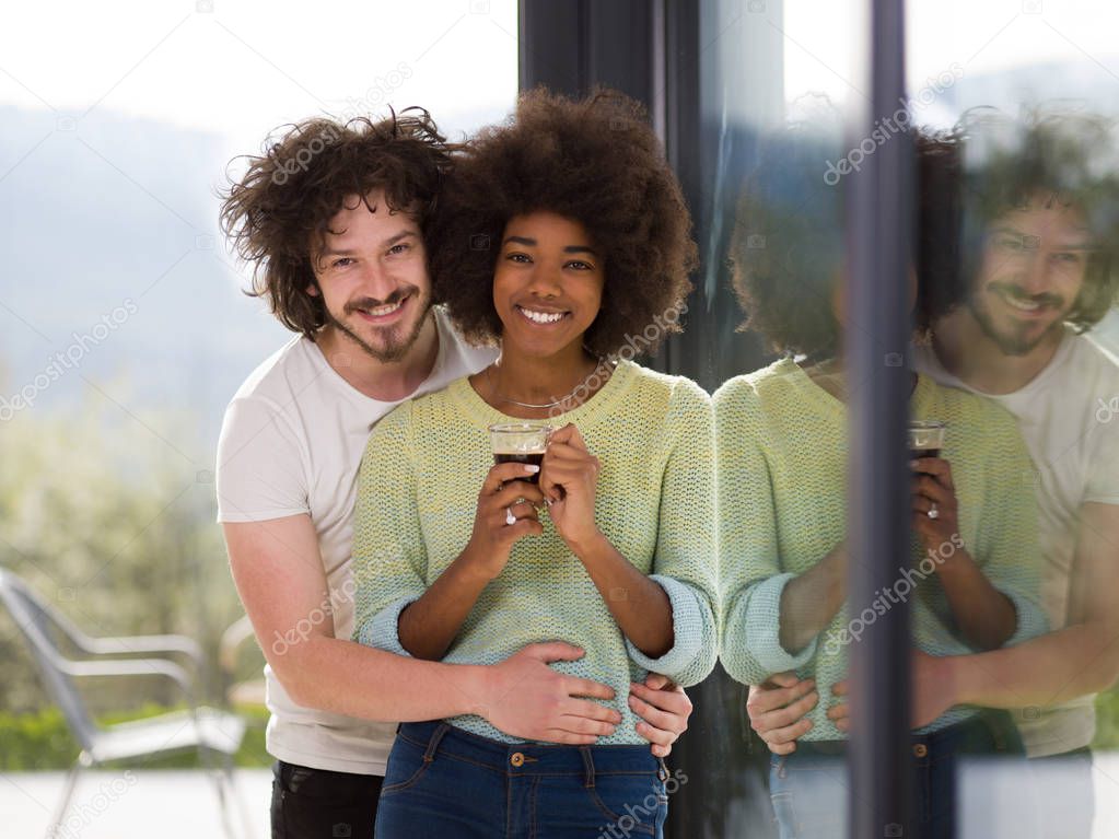 happy multiethnic couple relaxing at modern home indoors