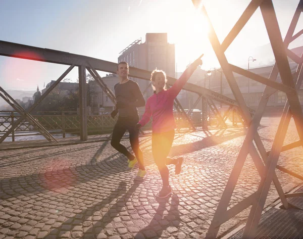 Gezonde jonge paar joggen in de stad — Stockfoto