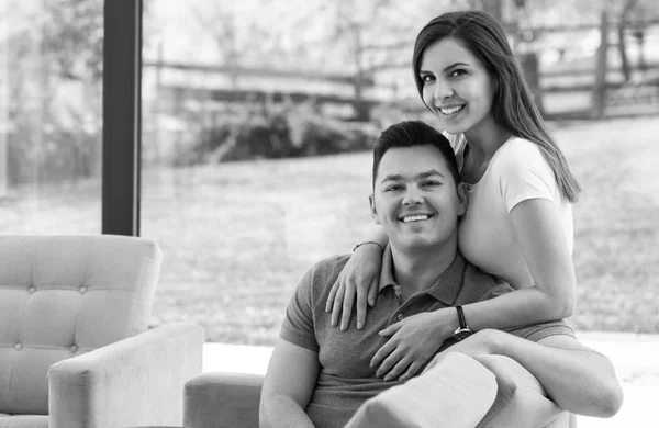 Two cheerful lovers sitting on the couch Stock Image