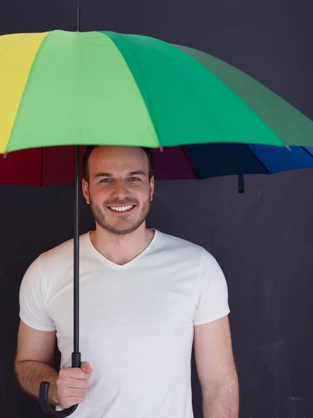 Hombre guapo con un paraguas colorido —  Fotos de Stock