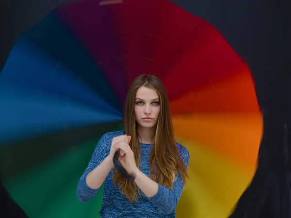 Handsome woman with a colorful umbrella — Stock Photo, Image