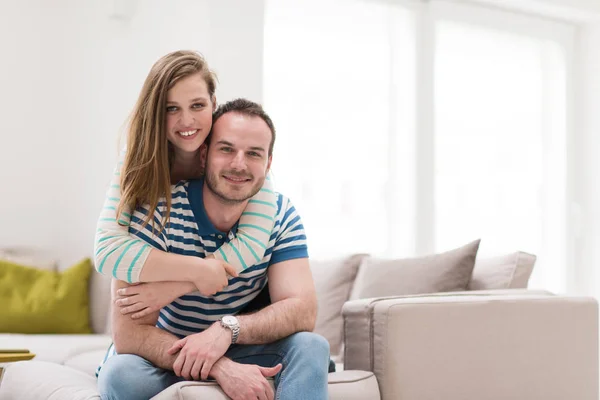 Jonge knappe paar knuffelen op de Bank — Stockfoto