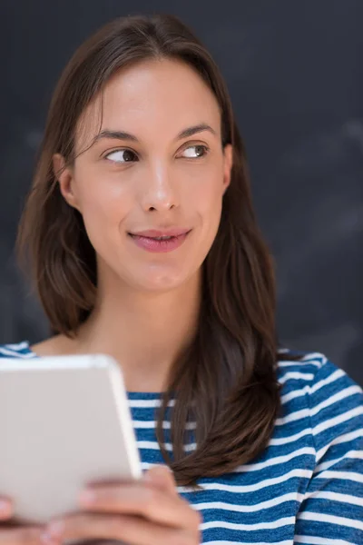 Женщина с помощью планшета перед доской рисования мелом — стоковое фото