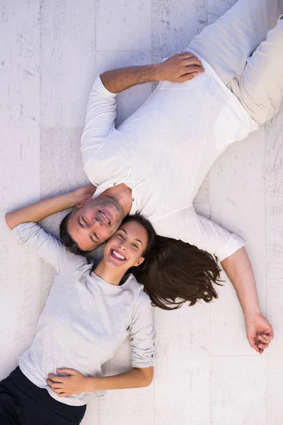 Handsome couple lying on floor — Stock Photo, Image