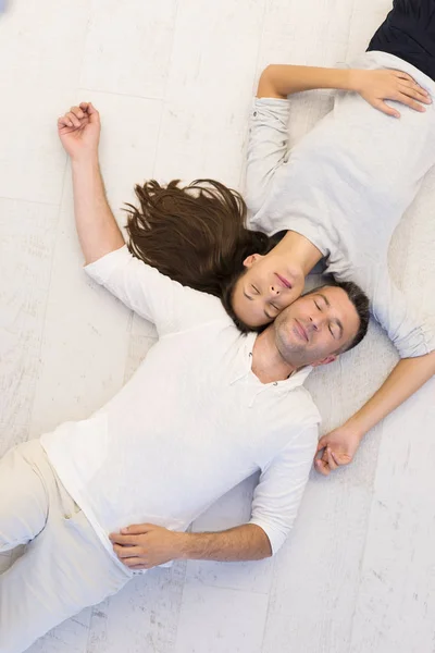 Handsome couple lying on floor — Stock Photo, Image