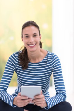 tablet bilgisayar yere kullanan genç kadın