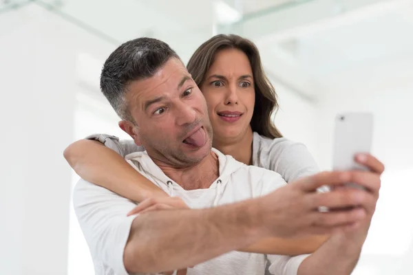自宅で携帯電話を使用して幸せなカップル — ストック写真