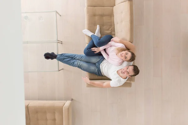 Young couple on the sofa watching television top view — Stock Photo, Image