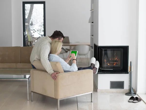 Young Couple in front of fireplace — Stock Photo, Image