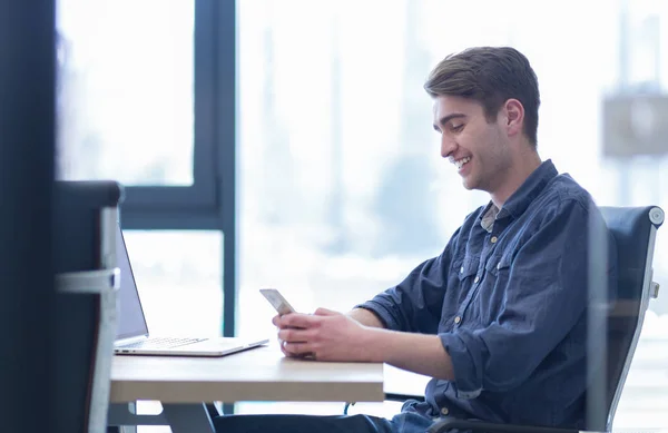 Jovem empresário casual usando smartphone — Fotografia de Stock