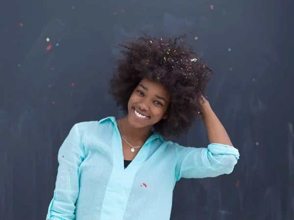 Black woman blowing confetti in the air — Stock Photo, Image