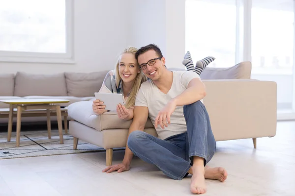 Casal relaxante em casa com computadores tablet — Fotografia de Stock