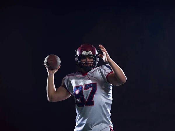 american football player throwing rugby ball