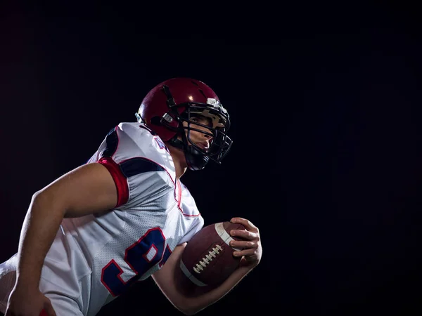 American Football-Spieler hält Ball, während er auf dem Feld läuft — Stockfoto