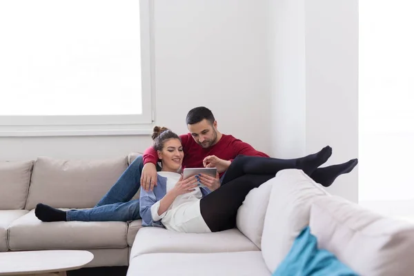 Casal relaxante em casa com computadores tablet — Fotografia de Stock