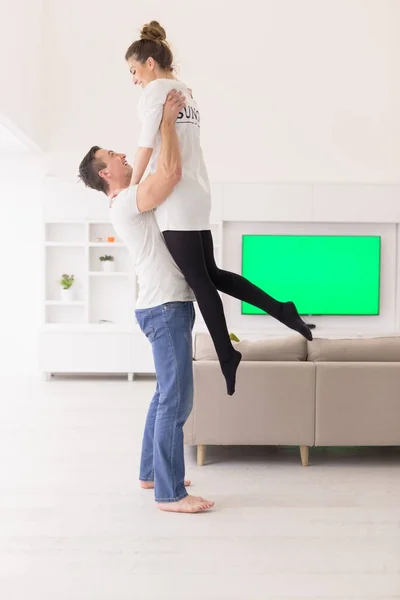 Couple hugging in their new home — Stock Photo, Image