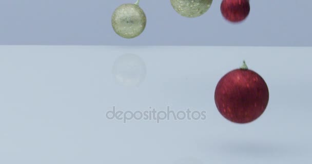 クリスマス ボールと装飾の赤とゴールデン ドロップし 反射する白い背景にスローモーションでバウンス — ストック動画