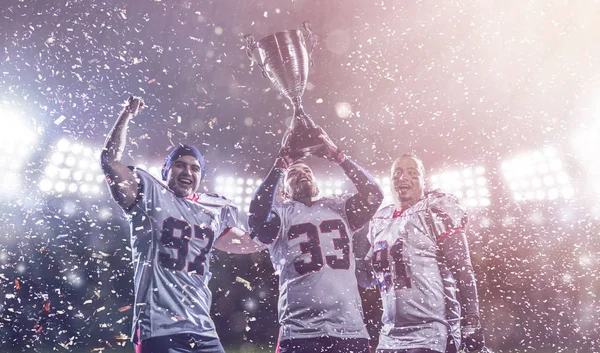 American football team with trophy celebrating victory in the cu — Stock Photo, Image