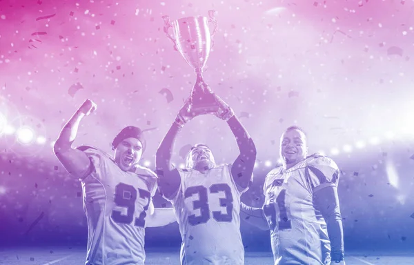 American football team with trophy celebrating victory in the cu — Stock Photo, Image