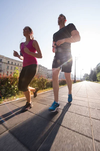 Young couple jogging  in the city — Stock Photo, Image