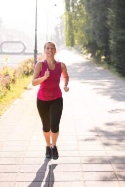 Sportif kadın şehirde güneşli sabah koşu