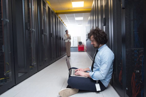 Team of young technicians working together on servers — Stock Photo, Image