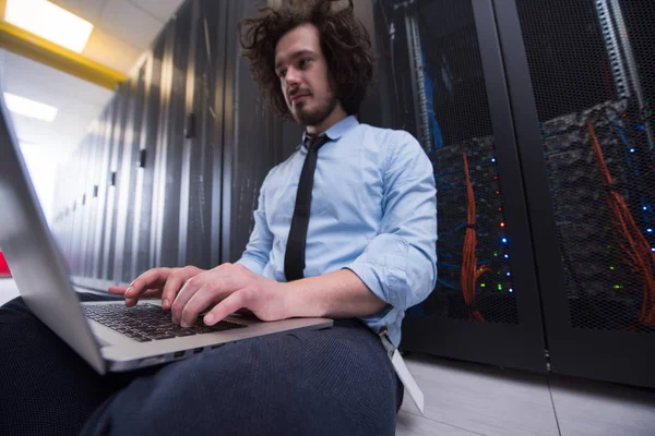 Engineer working on a laptop in server room — Stock Photo, Image