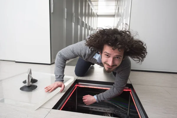 Ingénieur connectant les câbles dans la salle des serveurs — Photo